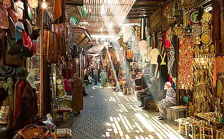 Sunlit covered lane of a souk in the Fes medina